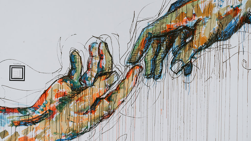 A painting of two human hands about to touch.